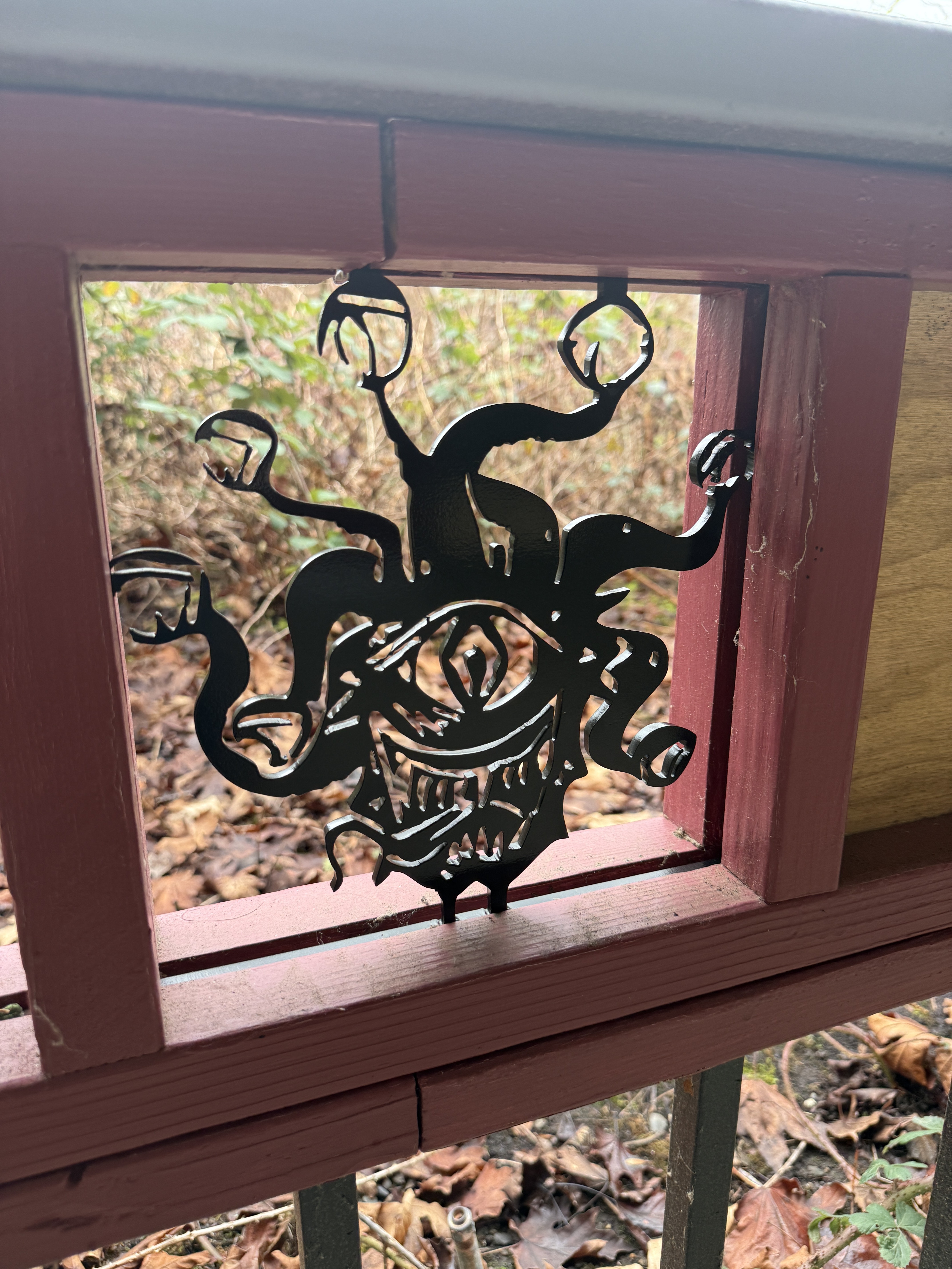 Plasma-cut metal creature silhouette in a wooden frame