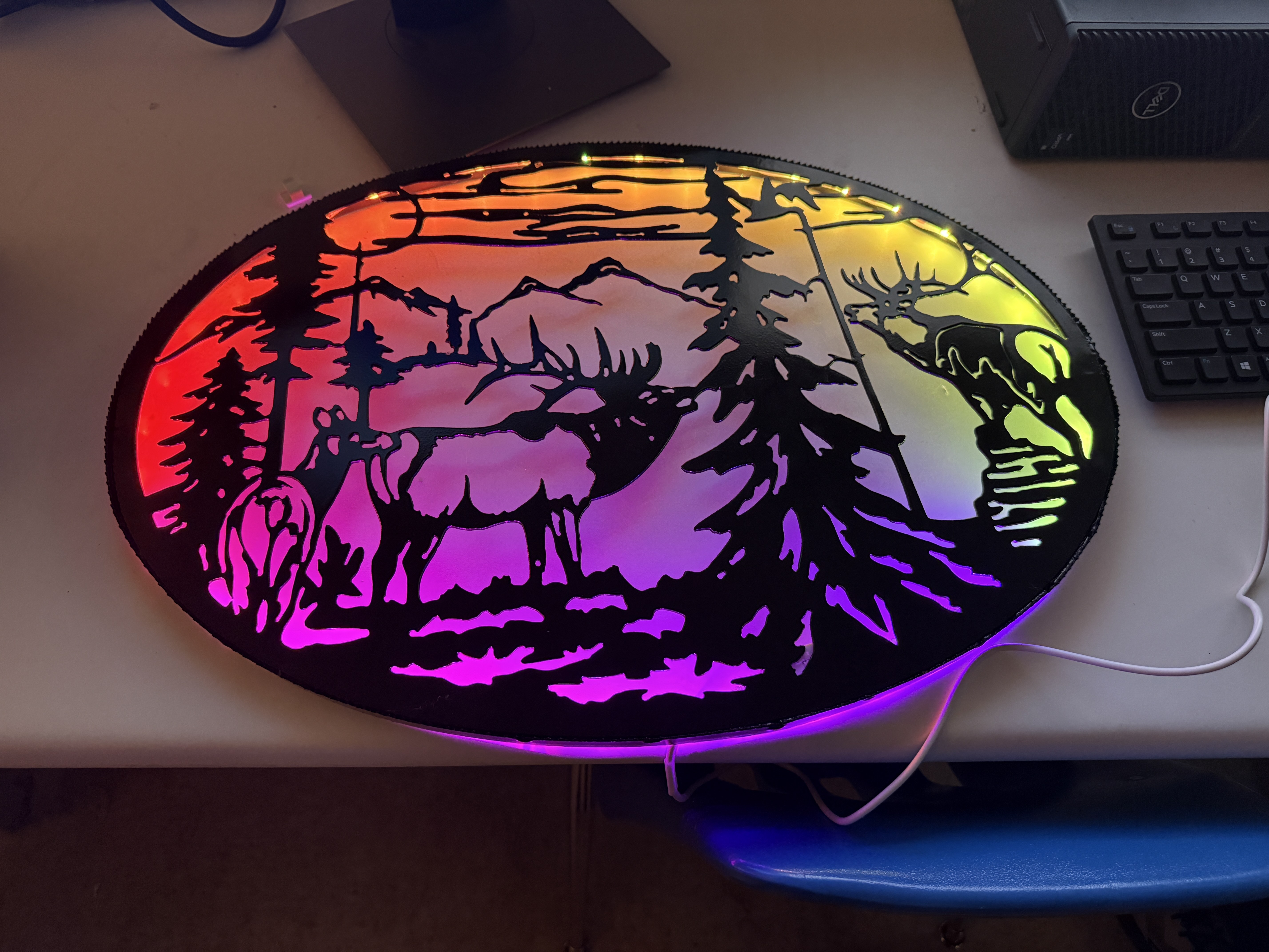Plasma-cut metal wildlife panel with rainbow LED backlighting